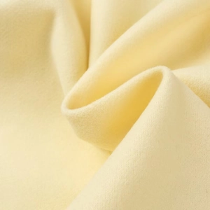 Fashionable long yellow wool coat for women featuring premium soft textured fabric