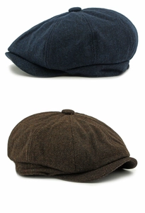 Detail of herringbone wool newsboy caps in navy blue and brown with top buttons