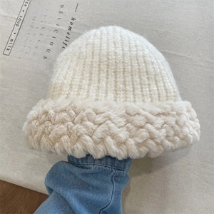 Close-up of thick white plush knitted beanie with soft warm texture for winter