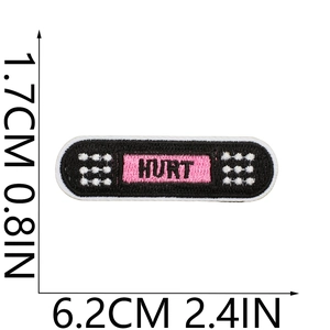 Macro shot of HURT embroidered patch showing exact dimensions in centimeters and inches