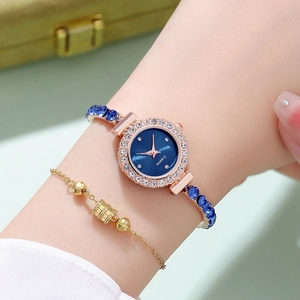 Detail of rose gold quartz watch with blue gemstone bracelet and rhinestone bezel