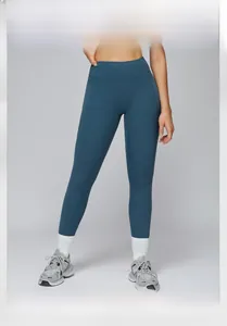 Detail view of high waist yoga pants in matte blue showing slimming compression seams