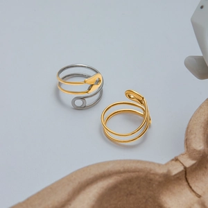 Detailed close-up of adjustable safety pin rings in gold and silver stainless steel