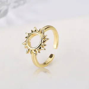 Detailed macro view of gold-plated sun-shaped ring featuring a hollow circular center
