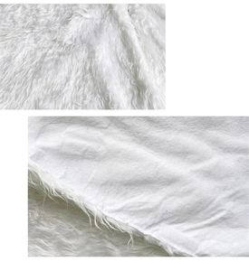Detail of white plush Christmas tree skirt showing faux fur texture and velcro closure
