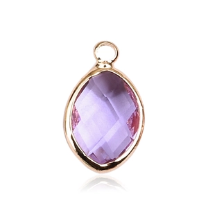Macro shot of purple marquise-cut glass pendant with a gold metal frame and top loop