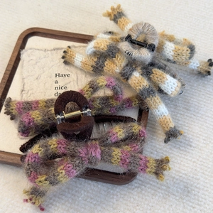 Set of two knitted wool bow claw clips in warm vintage stripe patterns for autumn and winter
