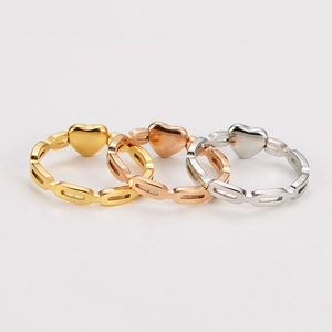 Detailed view of hollow geometric heart rings in gold, silver, and rose gold finishes
