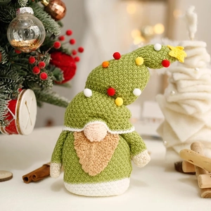 Green knitted Christmas gnome with tree hat and star decoration for festive holiday home decor