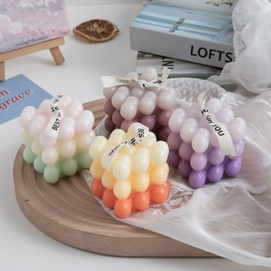 Set of four gradient bubble cube scented candles on wood tray for home decor