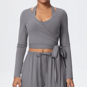 Detail of grey wrap yoga top with side ties and loose drawstring sports trousers