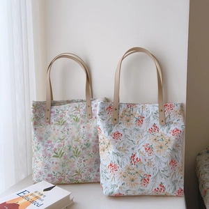French floral cotton tote bags with leather straps displayed in soft natural window light