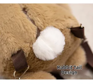 Detailed view of the soft plush backpack featuring a cute white rabbit tail design