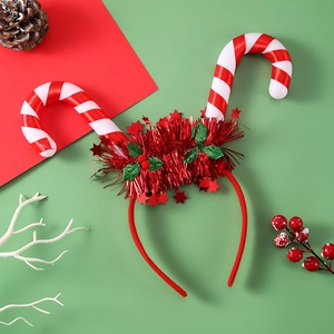 Detail of light-up Christmas headband featuring red candy canes and holly decorations
