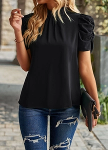 Detail of a black puff sleeve top with a mock neck and elegant lightweight drape