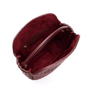 Chic burgundy woven leather mini handbag with top handle and interior pocket view