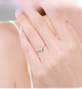 Close-up of S925 silver ring featuring a colorful zircon flower on a model's finger