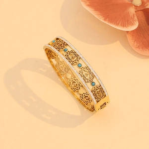 Detailed shot of hollow vintage gold bracelet with turquoise beads and inlaid crystals