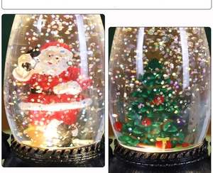 Detail showing Christmas snow globe lantern with Santa Claus and festive Xmas tree