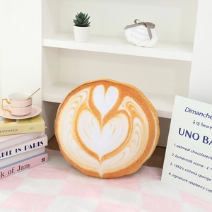Detail of round latte art plush pillow with realistic heart pattern on a cozy carpet