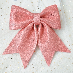 Close-up of a large pink glitter bow with a shimmering crystal texture for gift decoration