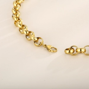 Detailed close-up of golden round link chain with a secure lobster clasp closure