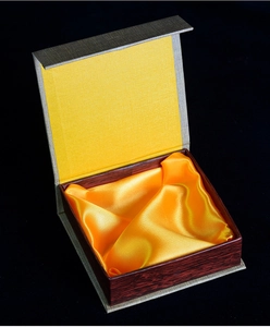 Detail view of premium gift box with grey exterior and luxurious yellow silk lining