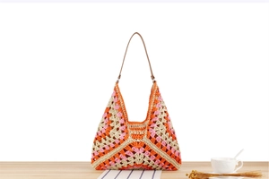 Macro detail of multi-color handmade woven paper rope tote with premium leather straps