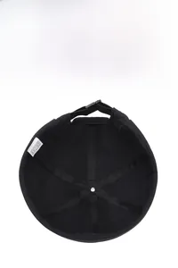 Detail showing internal reinforced structure and 100% polyester label of the black docker hat