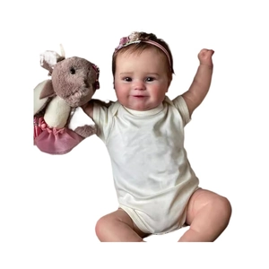 Lifelike 50cm soft silicone baby doll in beige outfit with pink headband and plush rabbit