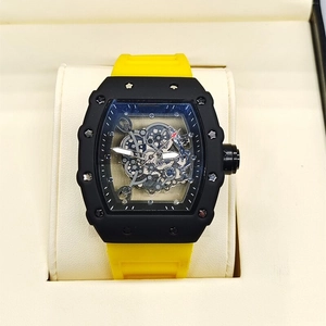 Close-up of skeleton dial mechanical watch with yellow rubber strap in a gift box