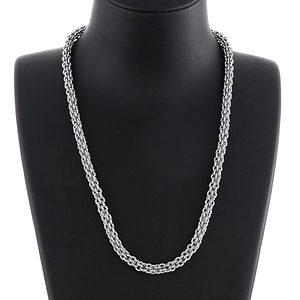 Sleek stainless steel lantern chain necklace worn on a black bust model, minimalist style