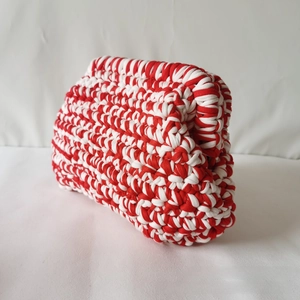 Detailed view of hand-knitted red and white crochet cloud bag with textured cotton cord
