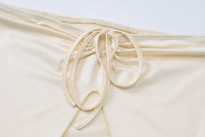 Detailaufnahme des beige gerüschten Rockbunds mit verstellbarem Kordelzug und Textur