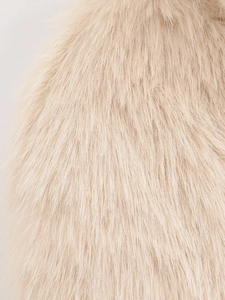 Macro detail of high-quality beige faux fur texture with soft glossy finish on a lapel coat