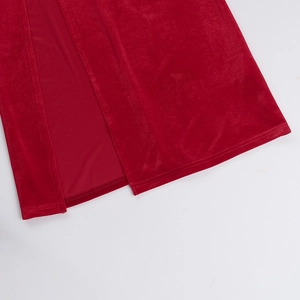 Detailed close-up of side slit on red velvet elegant dress with premium fabric texture