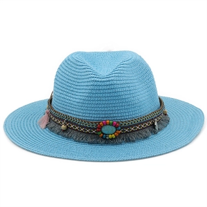 Detail of light blue straw hat featuring ethnic beaded band and turquoise stone decor