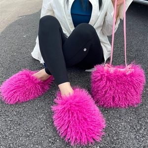 Close-up of pink faux fur bucket bag and matching plush shoes in bright daylight