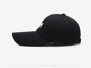 Side view of a black baseball cap with white embroidery and an extended brim visor