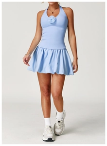 Detail of the light blue tennis dress featuring a 3D rose accent and pleated skirt