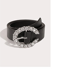 Detailed view of the black leather belt featuring a crystal-encrusted horseshoe buckle