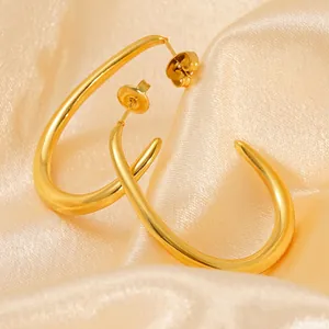 Irregular U-shaped 18k gold plated stainless steel hoop earrings on champagne silk fabric
