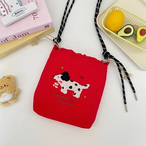 Close-up of red canvas bucket bag featuring cute dalmation embroidery and drawstring closure