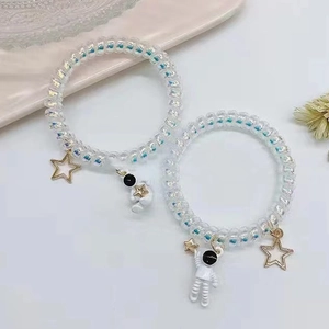 Holographic telephone wire bracelets with white astronaut and gold star pendants set