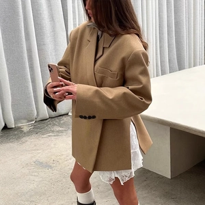 Women's brown oversized blazer with shoulder pads and side slits for a commuter style