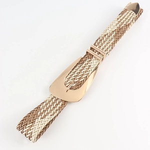 Detail of hand-woven bohemian waist belt with gold irregular buckle and metallic end tip