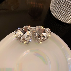 Sparkling vintage heart-shaped rhinestone earrings with crystal halo in macro shot