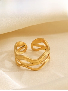 Detail of 18K gold plated multi-layer wavy ring on elegant beige satin fabric