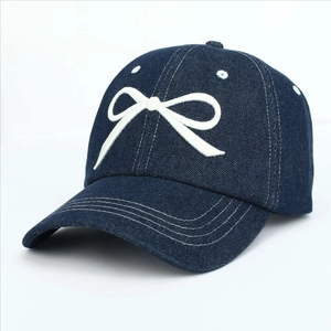 Dark blue denim baseball cap with white embroidered bow and stitched wide brim