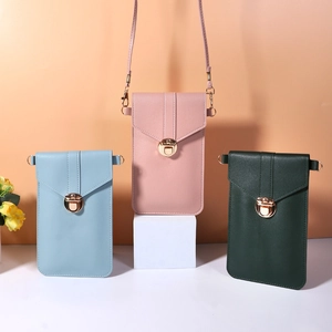 Detail view of mini phone crossbody bags in light blue, pink and dark green PU leather